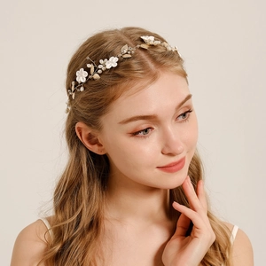 Handmade bridal headband featuring white ceramic flowers, gold leaves and pearls