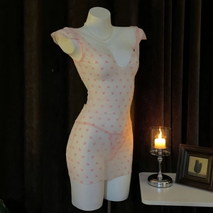 Detailed view of pink mesh mini dress with bow embroidery and deep V-neckline lace trim