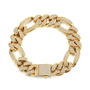 Hip hop style gold Figaro bracelet with paved white zircons on a clean white background