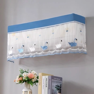 Detail of blue swan embroidery and white lace trim on a wall-mounted AC cover