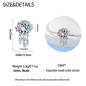 Macro detail of silver dreamcatcher moon bead with colorful enamel and feathers