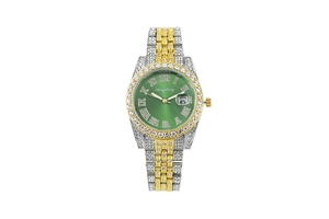 Close-up of green dial watch with Roman numerals, date window and crystal bezel details