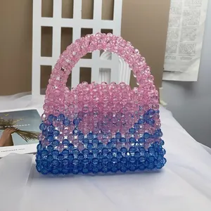 Detail of handmade beaded handbag featuring blue and pink gradient woven acrylic crystals