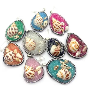 Macro detail of assorted colorful teardrop shell pendants with inlaid rhinestones and crystals