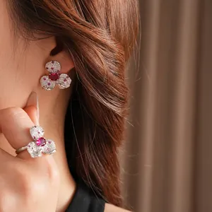 Vintage floral jewelry set featuring zircon petals and red gemstone on silver plating