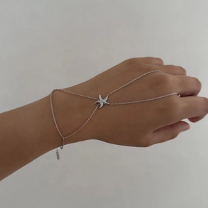 Silver stainless steel hand back chain featuring a minimalist starfish pendant charm