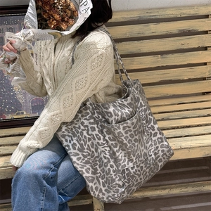 Lifestyle shot of grey leopard print canvas tote bag with front pocket for daily commute