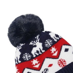Detail view of Christmas knit hat showing reindeer jacquard and soft faux fur pompom