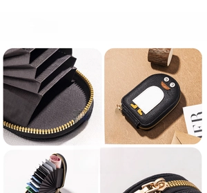 Detail view of penguin card holder showing internal accordion slots and cute design