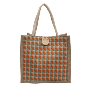 Jute tote bag with orange and teal plaid pattern, rope handles and wooden button closure