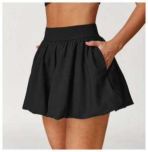 Detail of black high-waisted tennis skirt with bubble hem and functional side pockets