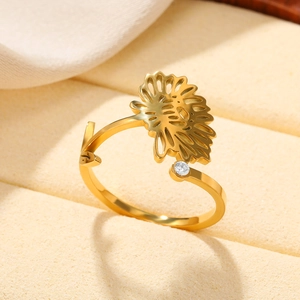 Detail of gold floral sunflower ring with zircon stone on beige velvet box