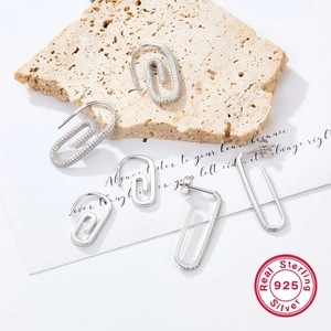 Detail view of S925 sterling silver paperclip earrings with cubic zirconia on stones