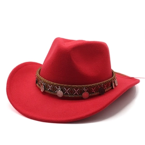 Detail of red wool felt cowboy hat featuring ethnic woven band and silver metal charms