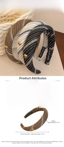 Close-up of striped fabric headbands with gold heart detail and handmade label