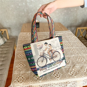 Ethnic woven canvas tote bag with Penang street art print and colorful handle