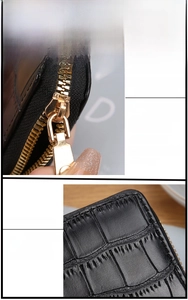 Detail view of black crocodile pattern leather wallet with premium gold zipper and neat stitching