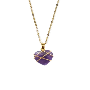 Detailed close-up of wire-wrapped heart amethyst pendant on a golden chain necklace