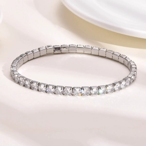 Detailed close-up of sparkling square-cut zircon stones on a silver tennis bracelet