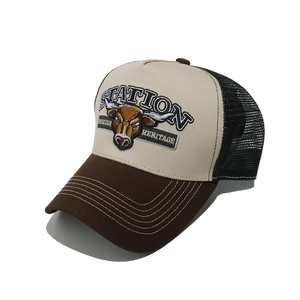 Detail of steer head embroidery on the khaki and brown mesh back trucker hat
