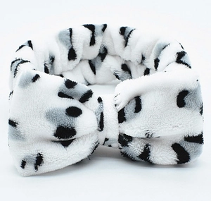 Gros plan du bandeau en polaire corail douce avec motif léopard noir et blanc
