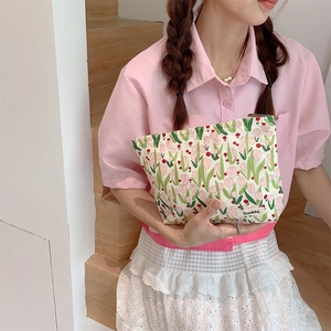 Detailed shot of tulip canvas cosmetic bag with zipper and branded woven label