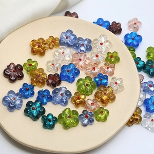 Colorful floral glass beads for DIY jewelry making displayed in a cream ceramic bowl