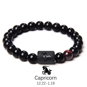 Detail of Capricorn bracelet with black obsidian beads and tiger eye stone inlay