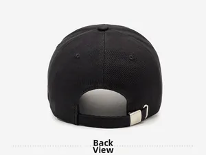 Detail view of the black corduroy baseball cap with an adjustable metal buckle closure