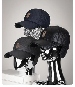 Detail of quilted winter baseball caps with earflaps in black, navy, and dark grey