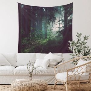 Detailed close-up of forest landscape tapestry hanging over white sofa in modern room