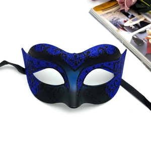 Detail of blue glitter masquerade mask with matte black finish and ribbon ties