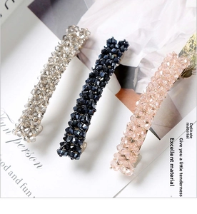 Close-up of handmade crystal beaded hair clips in silver, navy blue and champagne pink