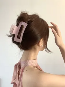 Macro detail of large translucent pink rectangular hair claw clip with matte resin finish