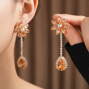 Luxurious flower and teardrop earrings set with amber crystals and sparkling cubic zirconia