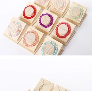 Close-up of wooden jewelry display stands with colorful beaded bracelets and necklaces
