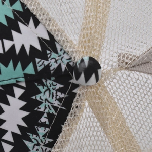 Macro detail of geometric print fabric and breathable beige mesh on a ponytail baseball cap