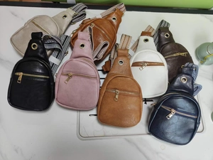 Selection of vegan leather chest bags in multiple colors with woven shoulder straps