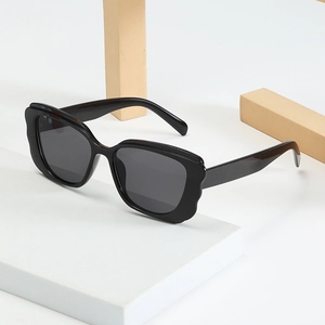Chic butterfly frame sunglasses in glossy black with wave edge design at a 45-degree angle