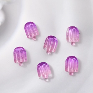 Macro shot of 6 purple gradient resin ice cream charms with glitter for nail art
