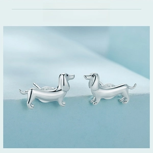 Macro detail of 925 sterling silver dachshund dog stud earrings with polished finish