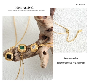 Macro shot of square gemstone pendant necklace with vintage brushed texture and bead chain