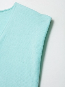 Detailed close-up of light blue fine knit fabric texture and ribbed edge finish