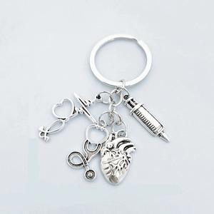 Medical theme keychain with silver stethoscope, heart, syringe and ECG wave pendants