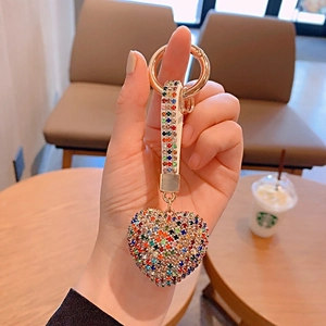 Detailed close-up of a sparkling rhinestone heart keychain with gold alloy finish
