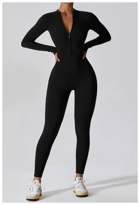 Close-up of the functional half-zipper neckline on a black high-stretch long-sleeve jumpsuit