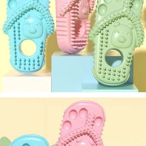 Close-up of slipper-shaped silicone dog teether with textured nubs for gum massage