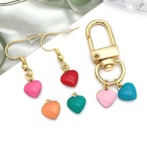 Detail view of colorful heart-shaped drip oil pendants for DIY jewelry and keychains