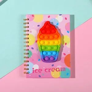Pink A5 spiral notebook featuring a rainbow pop-it ice cream silicone fidget toy on cover