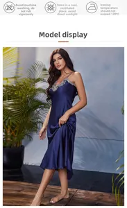 Detail of dark blue satin slip dress featuring elegant silver floral lace embroidery at the neckline